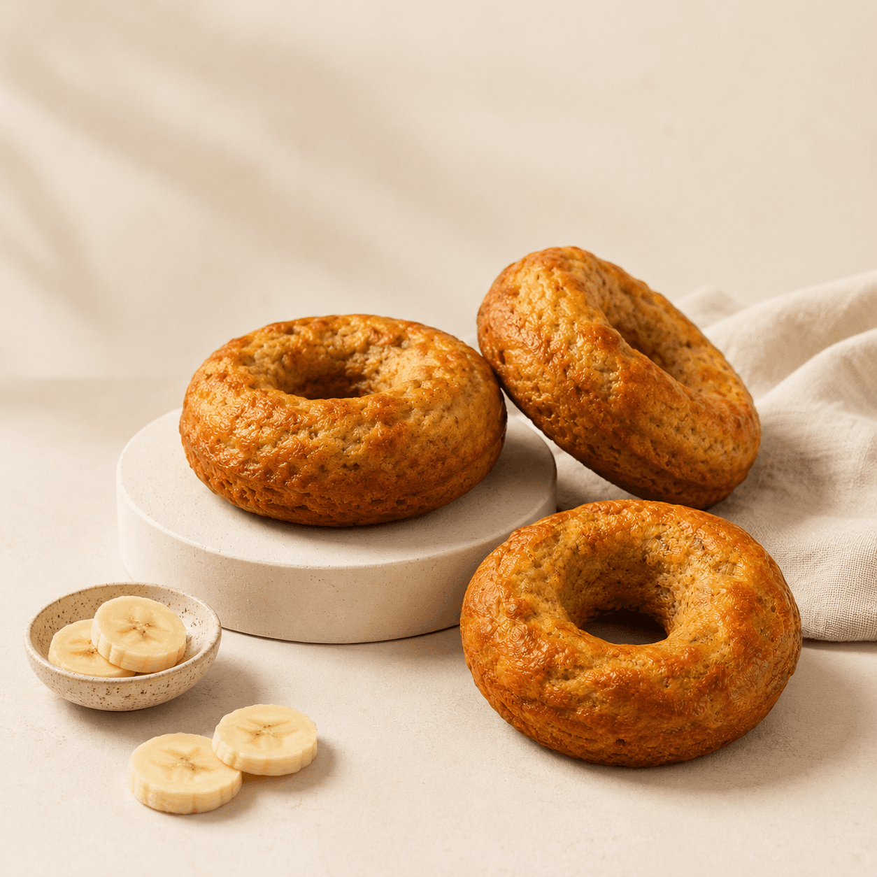 Styled Doughnanas with banana slices on a clean neutral surface